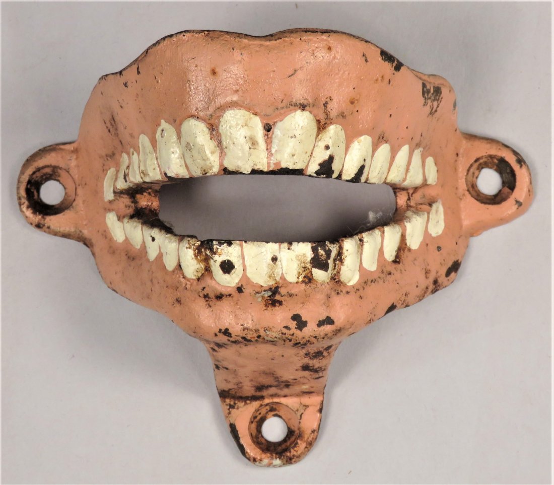 Hubley Iron False Teeth Wall Mount Bottle Opener: Hubley Cast Iron False Teeth Wall Mount Bottle Opener, ca. 1930's. Paint chips and rust. 3 1/2 inches wide.