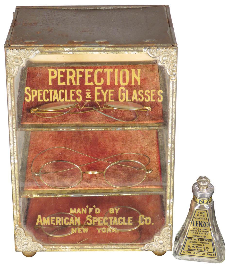 Perfection Spectacles & Eye Glass Store Display: Perfection Spectacles & Eye Glass Store Display. Man'f'd by American Spectacle Co. New York. Tin and glass with original decals. Comes with glass bottle of Lenzo glass cleaner and 3 pairs of glasses.