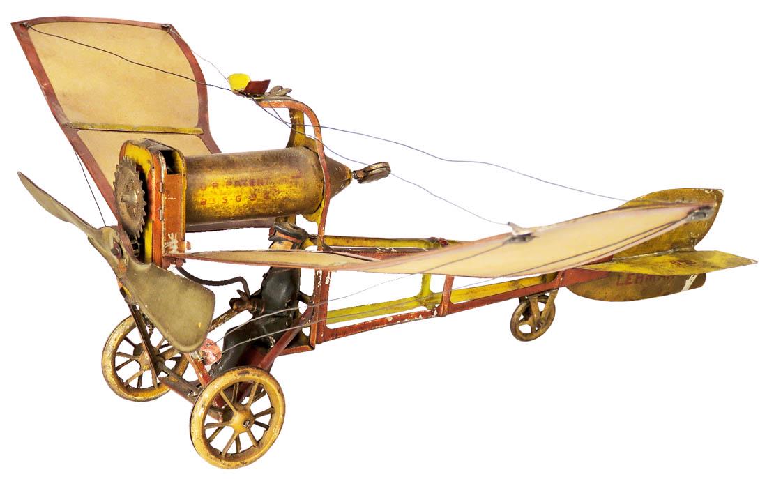 Lehmann Ikarus 653 Lithographed Tin Airplane Toy: Lehmann Ikarus 653 Lithographed Tin Airplane Toy, ca. 1920. Early monoplane. Yellow and red with paper backed wings and tinplate frame. Good original condition. 13 inch wingspan X 10 3/4 inches long.
