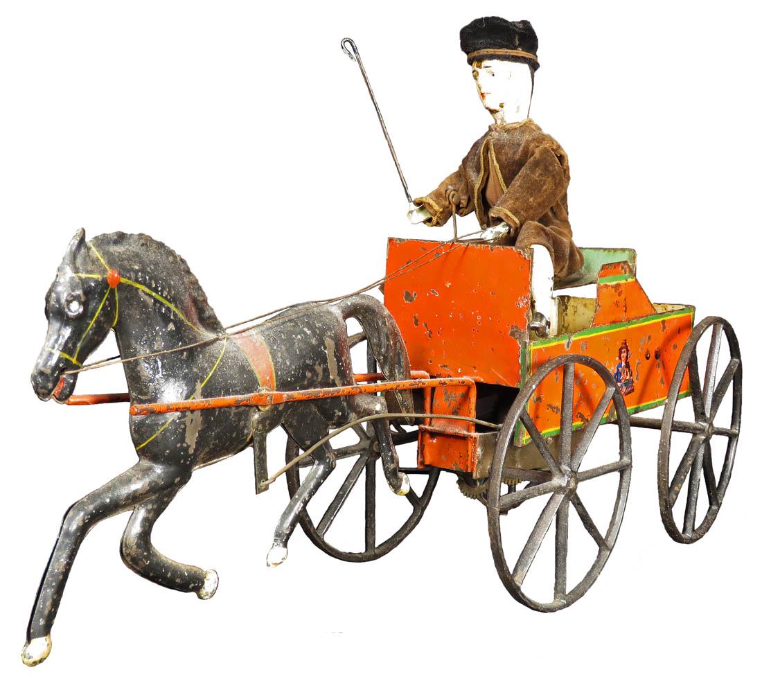 Ives, ca. 1870's Mechanical Horse & Buggy w/Driver: Ives, ca. 1870's Mechanical Horse & Buggy with Whipping Driver. Early hand painted tin wag with seated boy made of wood , cloth suit and hat, tin litho body, right leg detached. Works then gets hung u