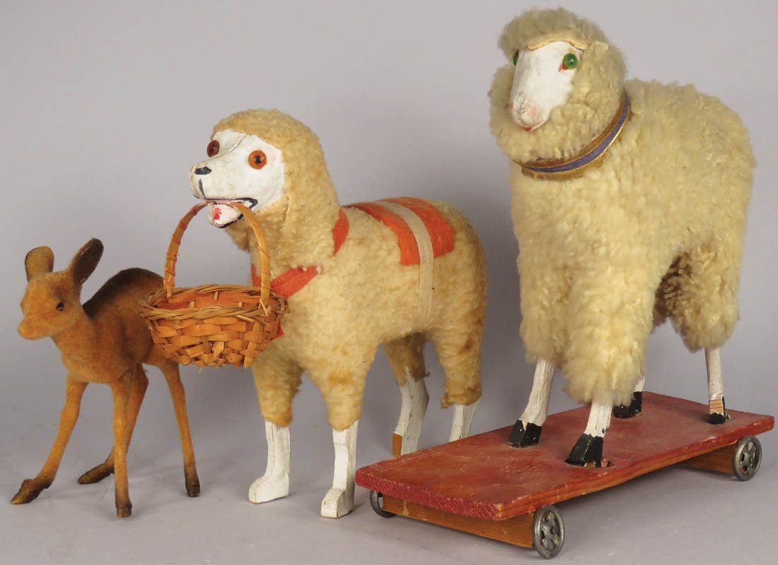 Assorted Vintage Children's Toys: Assorted Vintage Children's Toys. German Putz Wooley Wooden pull toy, 7 inches long. Paper Mache felt covered with glass eyes, basket in mouth. Flocked dear, 3 1/2 inches wide.