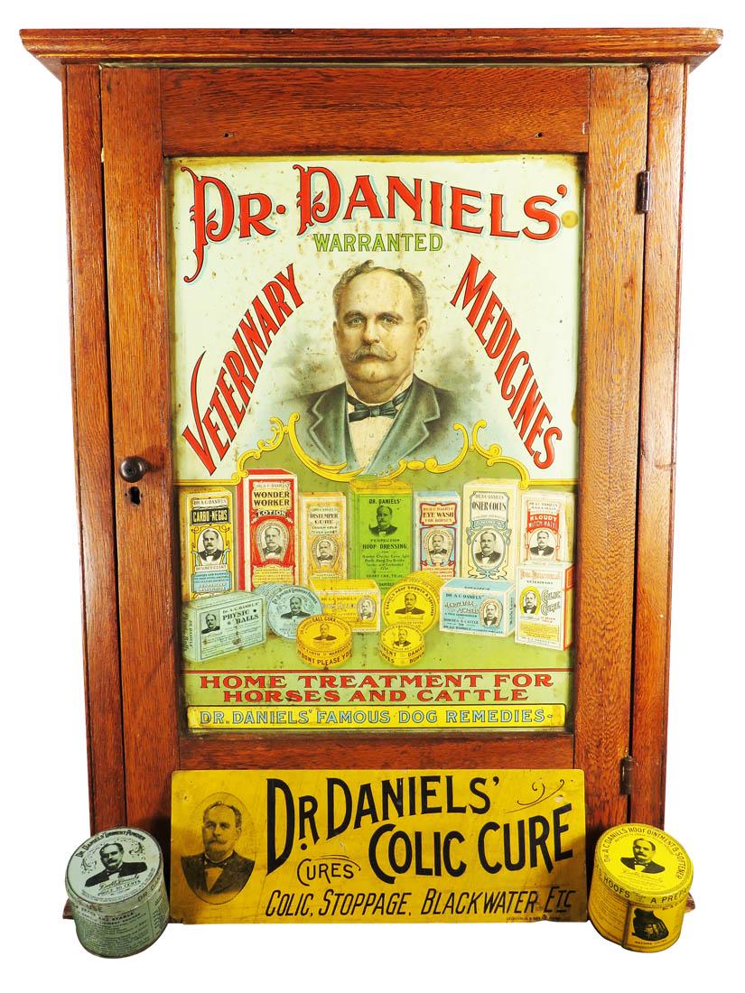 Dr. Daniels' Veterinary Medicines Cabinet: Dr. Daniels' Veterinary Medicines Cabinet. Embossed tin litho front. Dr, Daniels' Colic Cure cardboard sign 14 X 5 inches. Product tins Hoof Ointment and Liniment Powder.