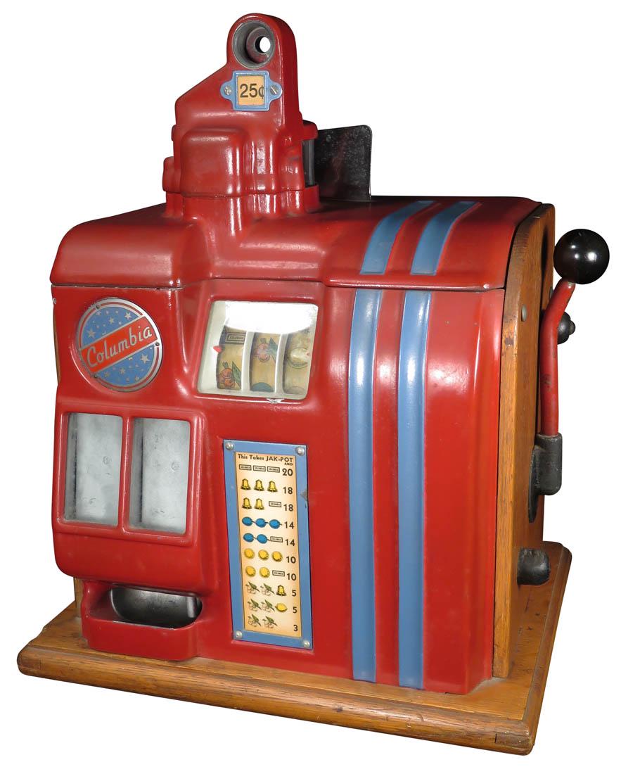 25 Cent Groetchen Columbia Slot Machine: 25 Cent Groetchen Columbia Slot Machine, ca. 1936. Small countertop slot machine with three small reels and twin jackpot bank. Painted matte red top and face with blue striping. Working condition, has