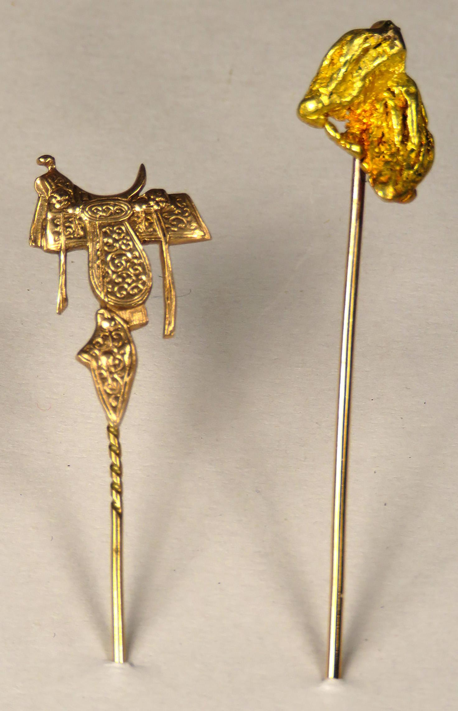 Two Antique Western Motif Stick Pins: Two Antique Western Motif Stick Pins. 10k gold engraved saddle and Gold Nugget. Saddle measures 3/4 of an inch.