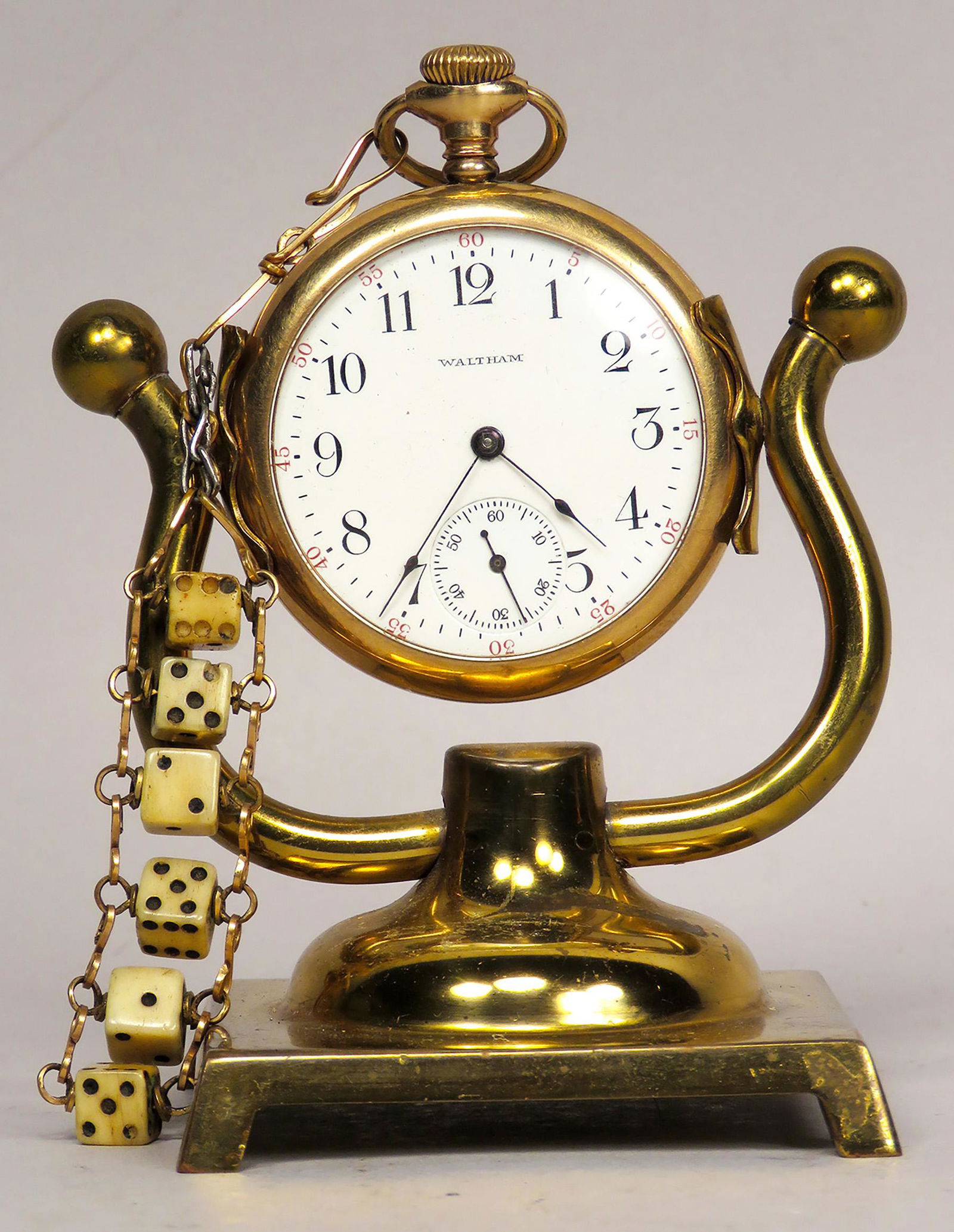 Brass Pocket Watch Holder, Watch and Dice Fob: Brass, Pocket Watch Holder with Watch and Dice Fob. Waltham engraved "naughty" gold filled case with open face. 6 tiny dice measures 4 1/4 inches long overall.