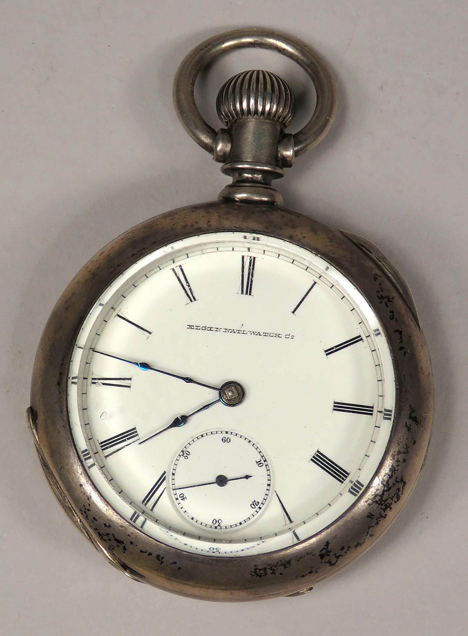 Elgin National Watch Company Pocket Watch: Elgin National Watch Company, Pocket Watch. Engraved coin silver case with Native American Motif, Indian holding skull, with open face. Serial # 1245974.