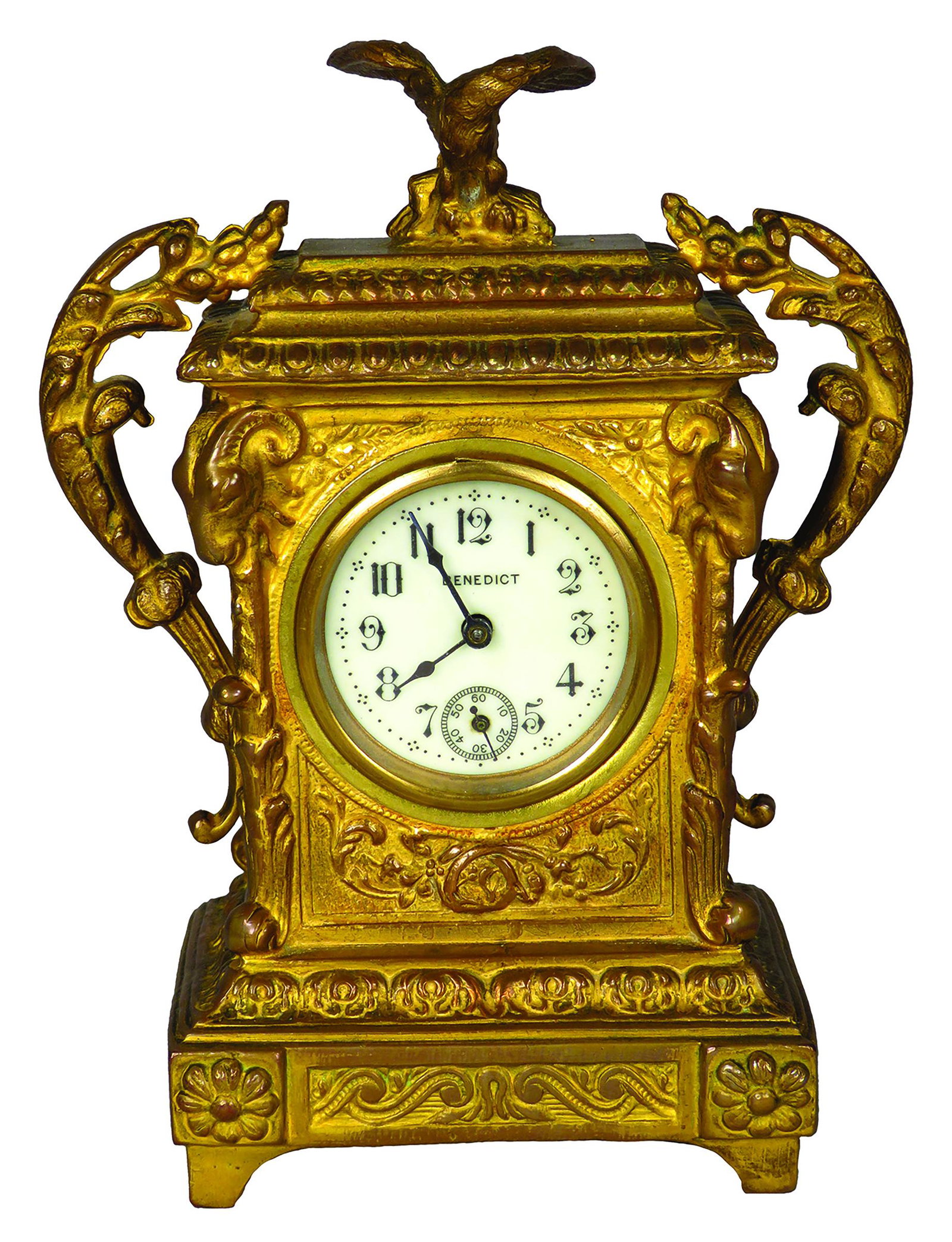 Antique Benedict Mfg. Co. Shelf Clock: Antique, Benedict Mfg. Co. Shelf Clock. Eagle and ram motif. Gold washed with porcelain face. 5 X 7 X 3 1/4 inches.