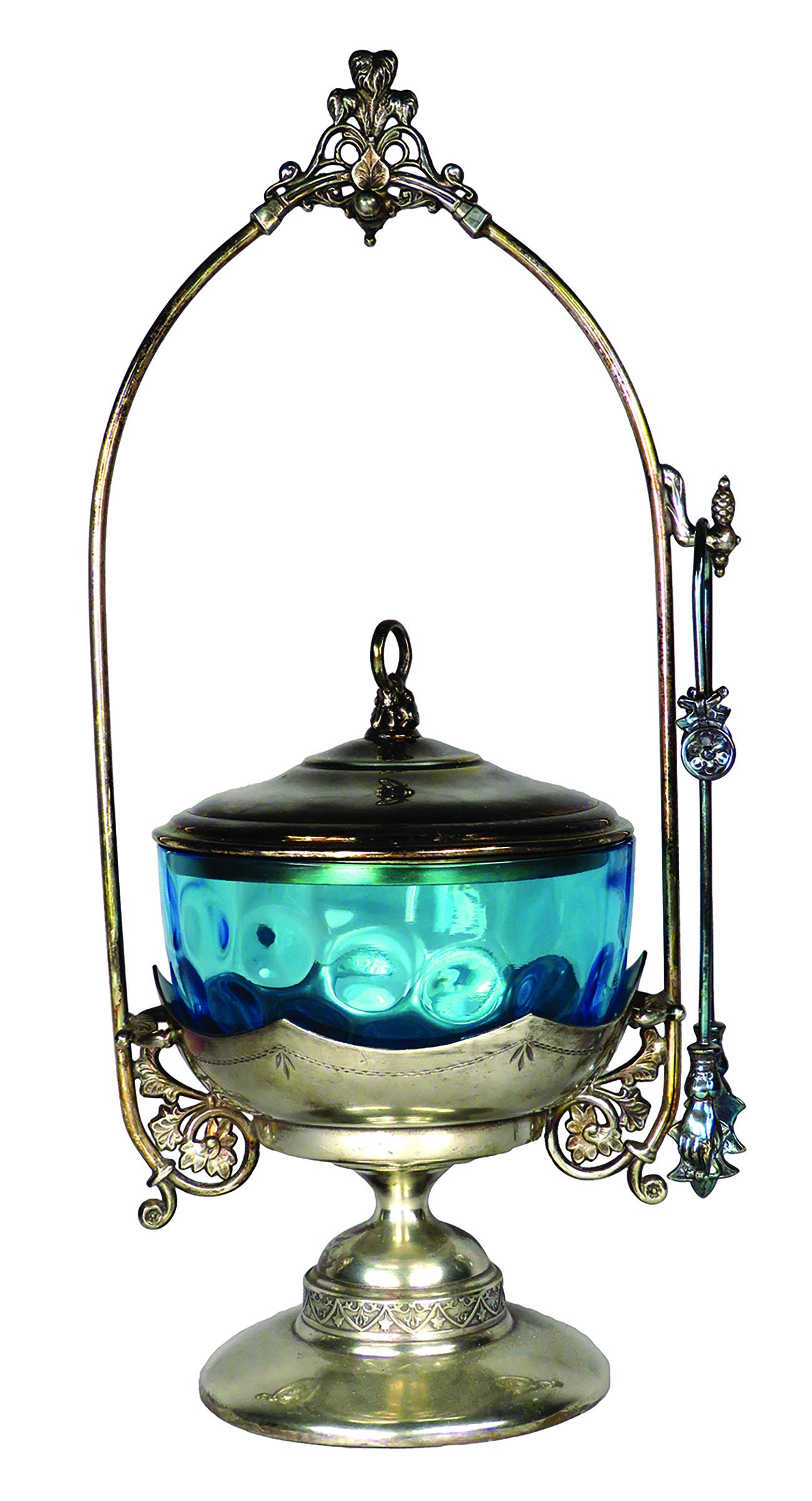 Aurora Mfg. Co. Silver Plate Victorian Pickle Caster: Aurora Mfg. Co. Silver Plate Victorian Pickle Caster. Silver plate with ring holder finial on lid, spot at top to hang lid. Aqua thumbprint glass, figural "hand" tongs. No chips or cracks. 13 1/4 inch