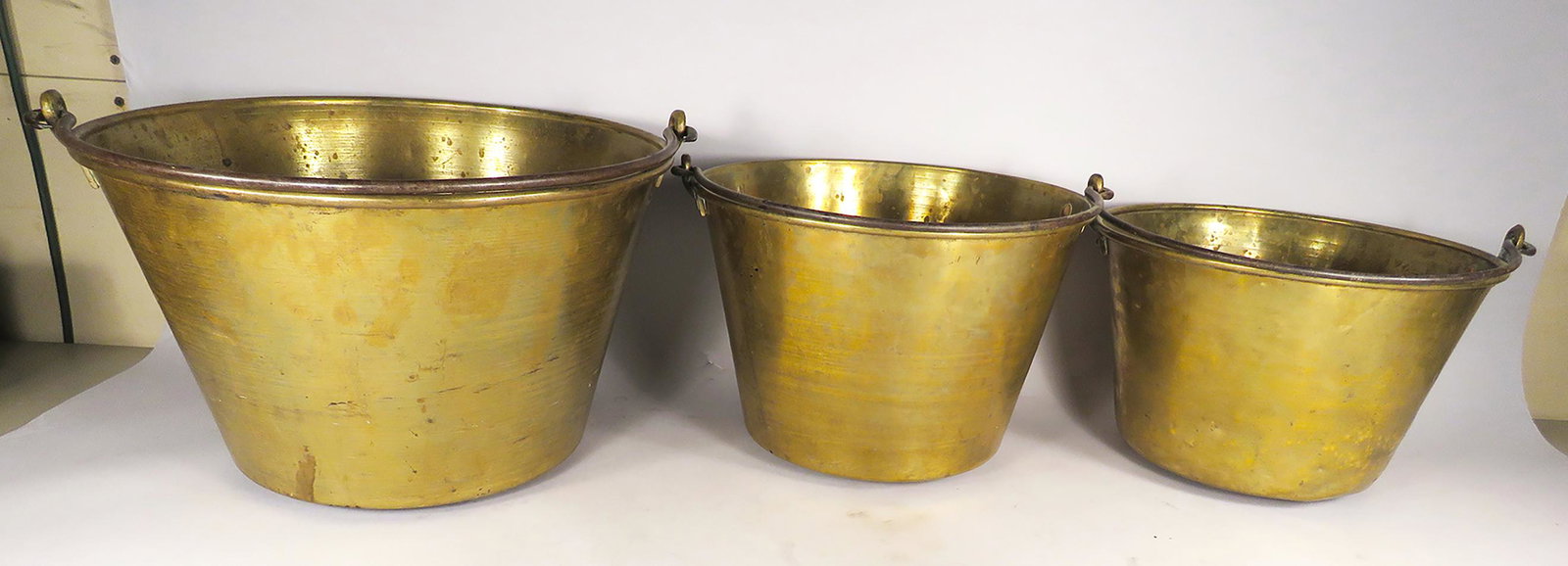 Three Antique Brass Pots: Three Antique, Brass Pots with bale handles. 12-15 1/2 inch dia. 8-10 inches tall.