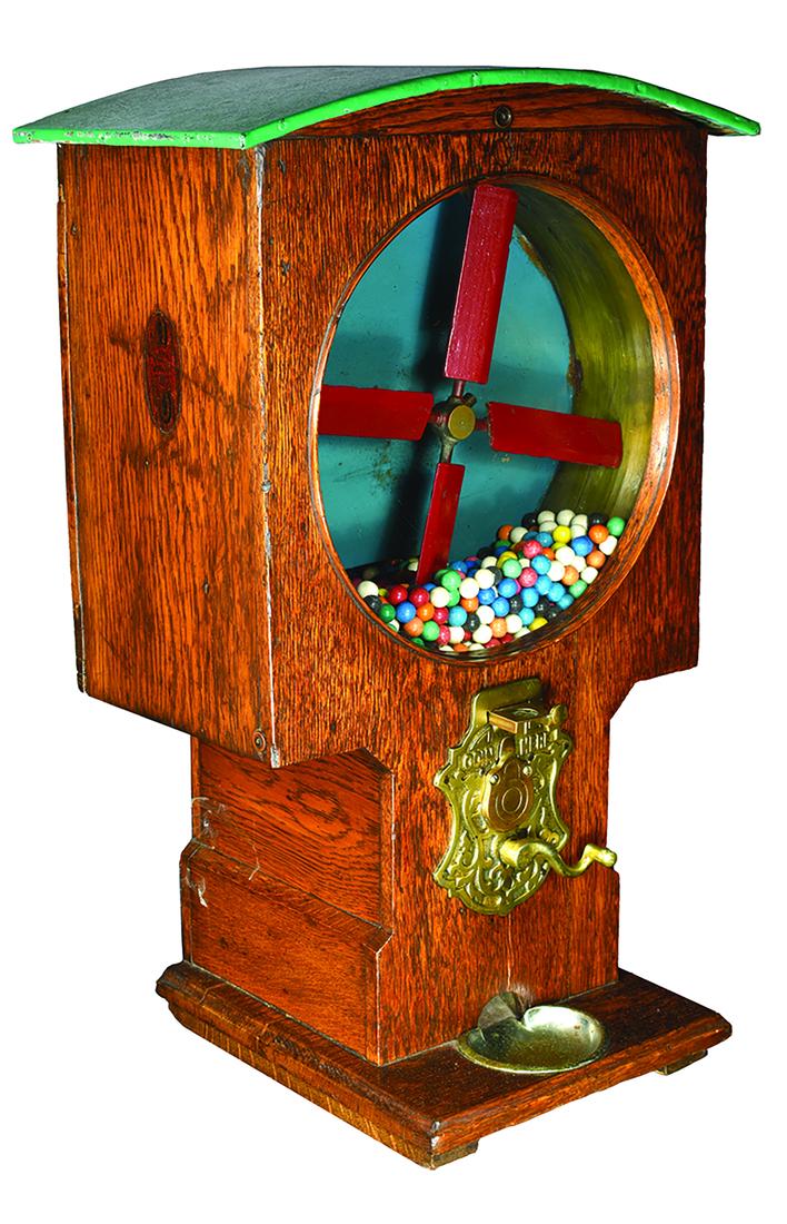 Mills, 1 Cent Gum Vending Machine. Circa 1898: Mills, 1 Cent Windmill, Gum Vending Machine. Circa 1898. Oak case with original decals and painted metal stand. Windmill turns and knocks the gum balls into a slot which then leads them to the outside