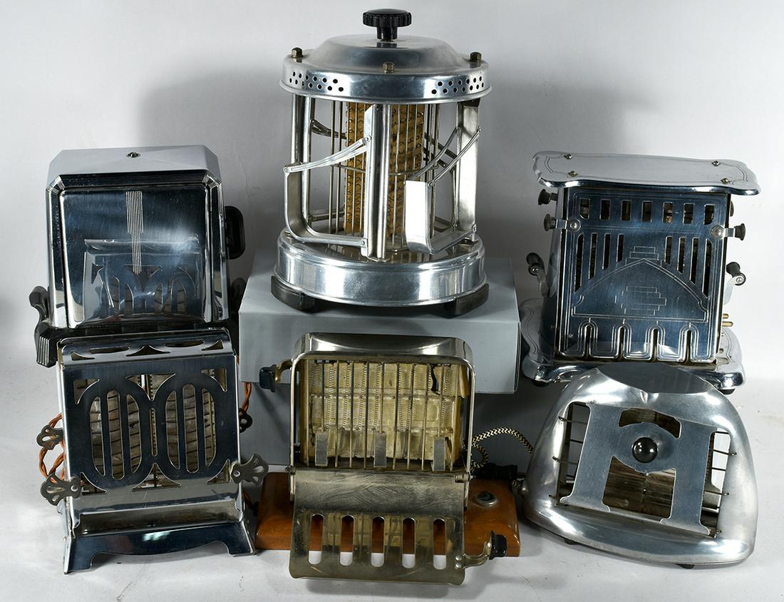 Collection of 6 Vintage Toasters: Collection of 6 Vintage Toasters. From left to right, back to front. Marked as follows: Westinghouse Turnover Toaster cat # TAC-3, 1914. Jura with wood base and on/off switch. No maker aluminum toaste