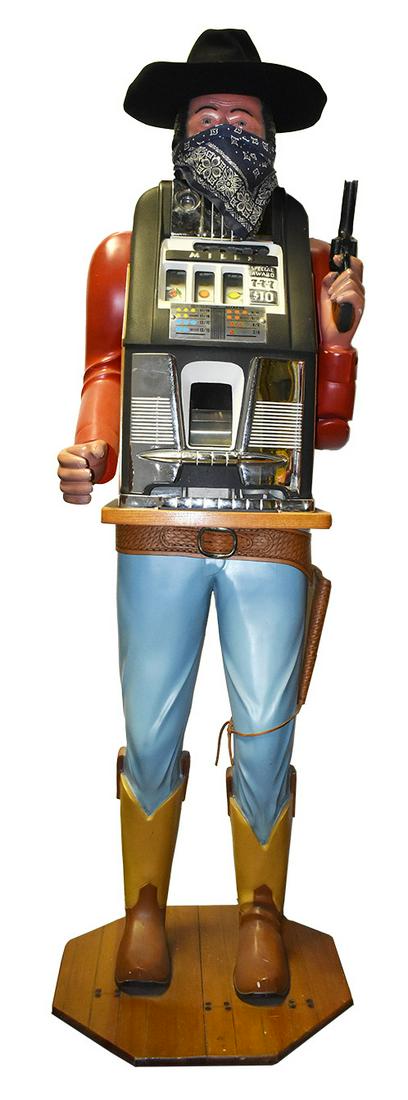 Mills 5 Cent One Armed Bandit Slot Machine: Mills, 5 Cent, Coin Operated One Armed Bandit, "Black Bart" Slot Machine. Carved mid-century. 74 inches overall w/hat.