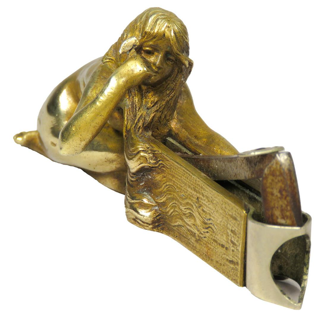 Art Deco Figural Brass Cigar Tip Cutter: Art Deco Figural Brass Cigar Tip Cutter. Depicting nude holding hammer. 4 inches long.