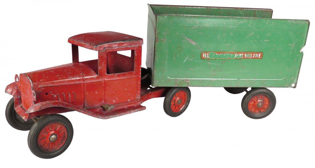 Buddy L Pressed Steel Toy Express Tractor Trailer: Buddy L Pressed Steel, Toy Express Line Tractor Trailer, ca. 1933. Red and green. Model #35. Original condition. Missing back door. Scratches and normal playwear. 24 inches long.