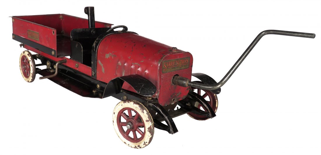 Structo Pressed Steel Toy Dump Truck Builder: Structo Pressed Steel, Toy Dump Truck Builder, ca. 1919. Red. Model 14, sliding gear transmission with forward and reverse. Wind up motor with crank handle. Original condition with heavy rubs and scra