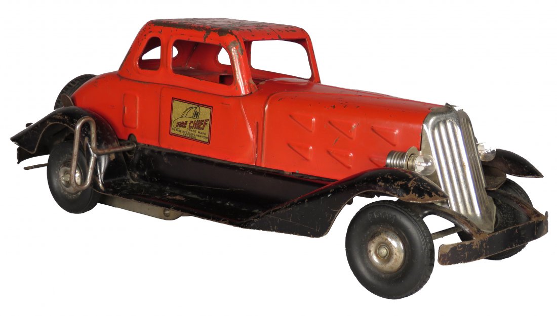 The Hoge Mfg. Co. Pressed Steel Toy Fire Chief Car: The Hoge Mfg. Co. Pressed Steel, Toy Fire Chief Car, ca. 1930. Wind up toy with battery operated headlamps. Original condition with paint loss and scratches. 14 inches long.