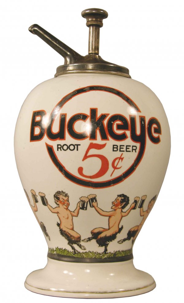 Buckeye Root Beer 5 Cent Syrup Dispenser: Buckeye Root Beer 5 Cent Syrup Dispenser. Decorated with baby satyrs around bottom perimeter. Early pump, not original. Some normal wear to logo on both sides otherwise good condition. 7 1/2 X 14 inch