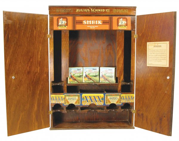 Julius Schmid Wood Condom Cabinet: Julius Schmid Wood Condom Cabinet. Comes with three display boxes of Peacocks Condoms. Wood cracked at the top marquee otherwise excellent condition. 13 X 3 3/4 X 18 1/4 inches.