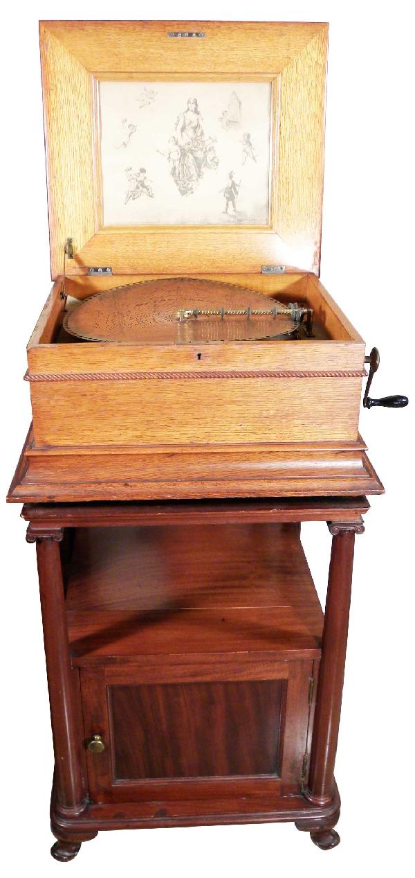 Regina Disc Player, Model 317: Regina Disc Player, double comb 15 1/2 inch disc. Table top with original oak case. Original paper lid insert. Comes with 5 discs. Excellent all original condition. 22 1/2 X 9 1/2 X 20 inches closed.