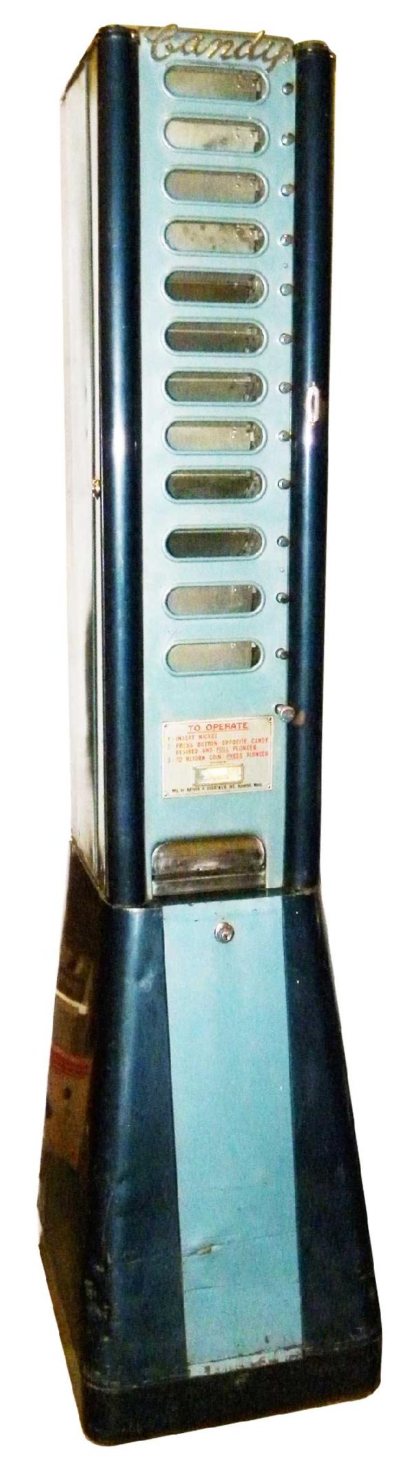 Coin Operated Candy Bar Vending Machine: Coin Operated Candy Bar Vending Machine. Mfg. by Arthur H. Dugrenier, Haverville, Mass. Pressed steel. A few dents in the base otherwise good original working condition. 17 X 72 1/2 X 19 inches.