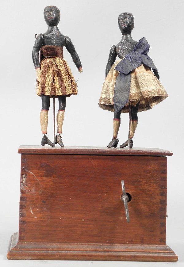 Clockwork Black Americana Dancers: Clockwork Black Americana Dancers. Original decal on walnut base. Some tattered clothing and missing hats otherwise good working condition, comes with key.