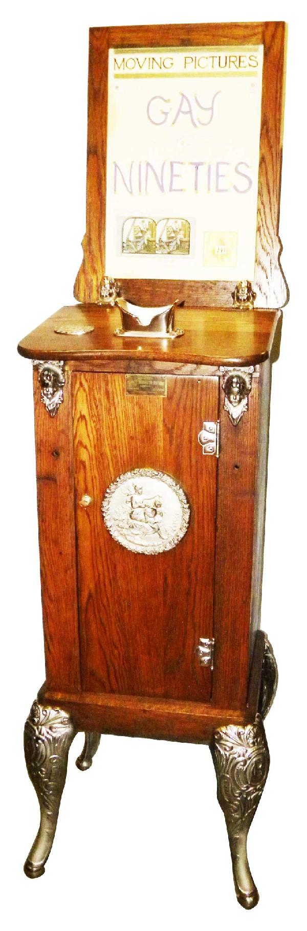 Caille Bros. Mutoscope 25 Cent Peep Show: Caille Bros. Mutoscope 25 Cent Peep Show. "Gay Ninety's". Oak cabinet. Drop card. Good condition comes with key. 20 X 73 X 18 inches.