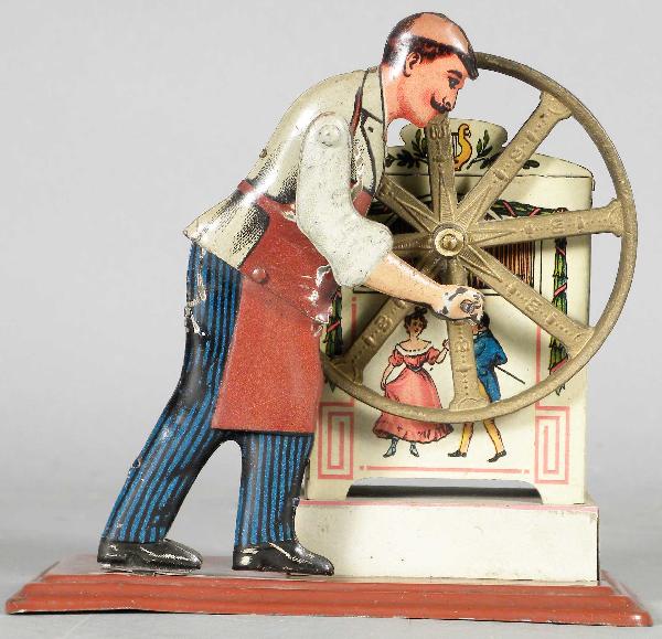 Mechanical Musical Tin Toy: Mechanical Musical Tin Toy, German made. Man winds up to play music. Excellent condition. 5 X 5 1/4 X 2 3/4 inches.