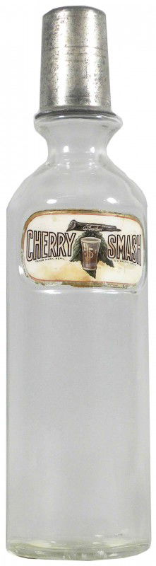 Fowler's Cherry Label Under Glass Syrup Bottle: Fowler's Cherry Smash 5 Cents Label Under Glass Syrup Bottle. Crack in top right and broken bottom left otherwise good condition. 12 1/2 inches tall. Crack on right top to bottom through "M" and missi