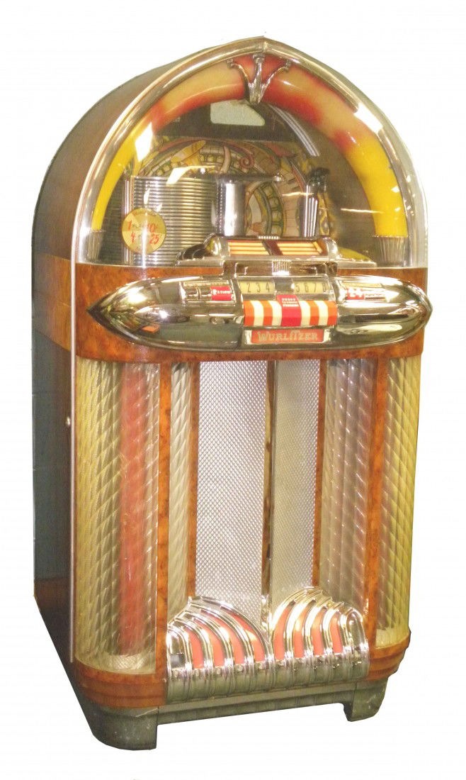 Wurlitzer Model 1100 Juke Box: Wurlitzer Model 1100 Juke Box. 1948 - 1949. First Jukebox made to incorporate the sensational Zenith Cobra Tone Arm and the First to use a ceramic cartridge rather than a magnetic one. Very colorful a