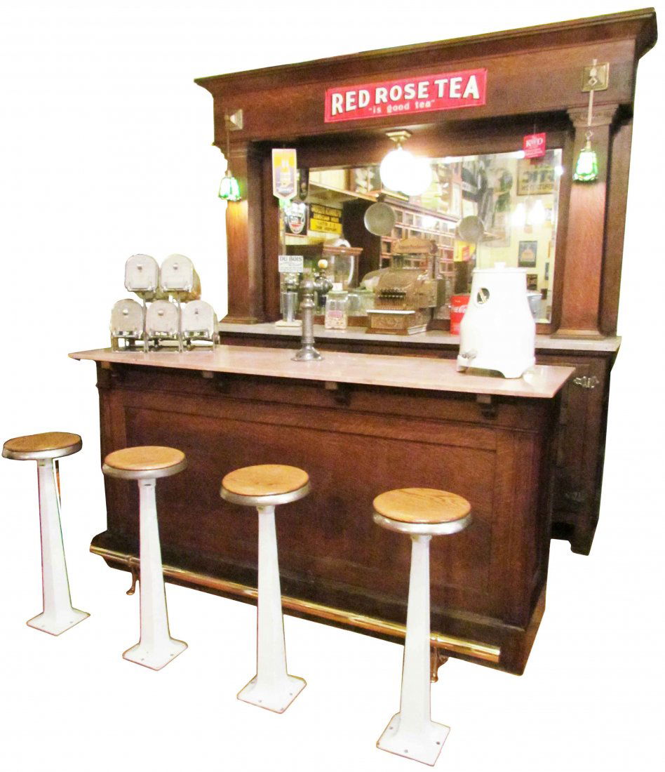 Late 1800's Oak Soda Fountain: Late 1800's Oak Soda Fountain. Beautiful quarter sawn oak, marble top. Ice box compartments and six stools. Original slag glass lamps and 5 Cent Brazilla Lamp Globe. Original fountain on front bar wit