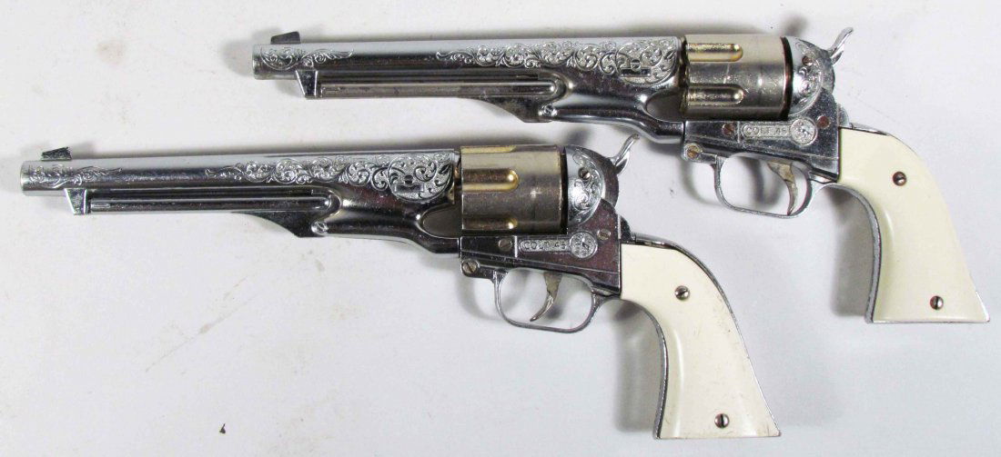 Two Hubley Colt 45 Die Cast Toy Cap Guns: Two Hubley Colt 45 Die Toy Cast Cap Guns. 8 inch barrel. A few scratches on grips otherwise good condition.