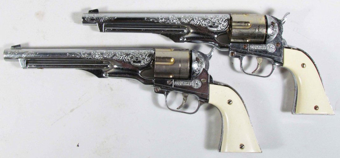 Two Hubley Colt 45 Die Cast Toy Cap Guns: Two Hubley Colt 45 Die Cast Toy Cap Guns. 8 inch barrel. Very good condition.