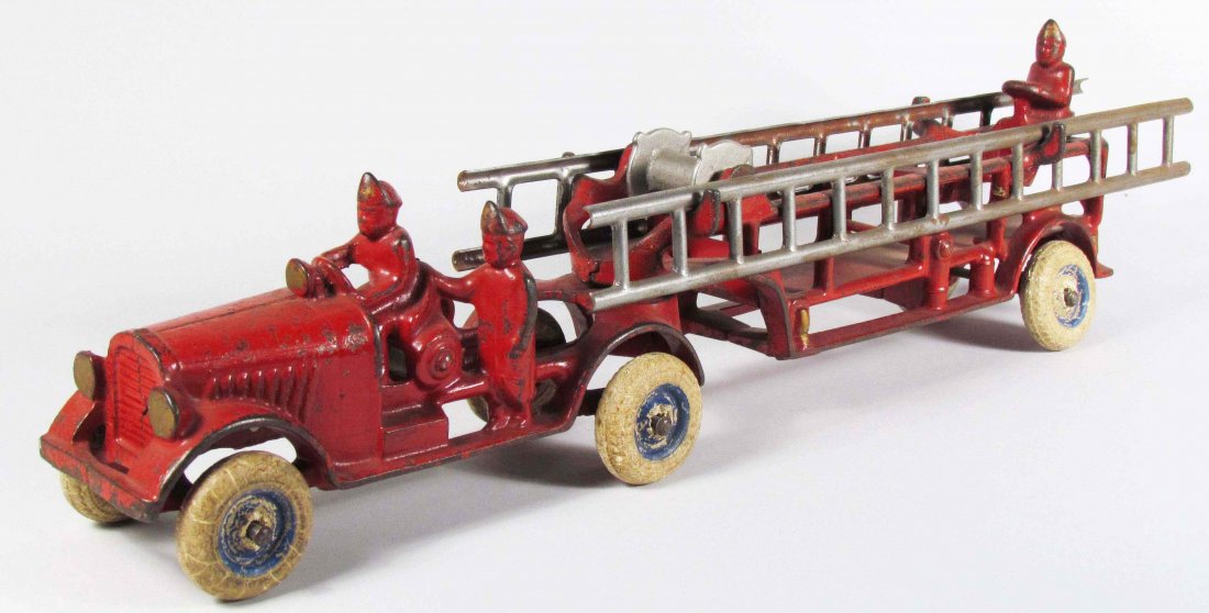 Arcade Cast Iron Ladder Truck Fire Toy: Arcade Cast Iron Ladder Truck Fire Toy with rubber tires. Most of the original paint intact. 18 inches long.