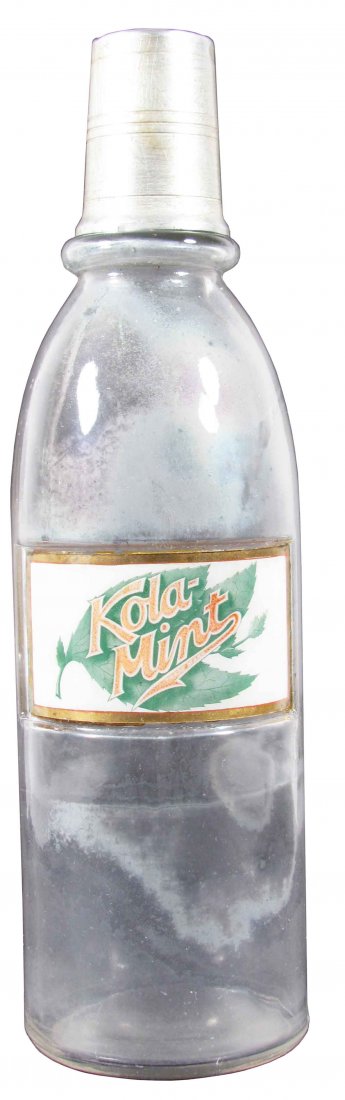 Kola-Mint Label Under Glass Syrup Bottle: Kola-Mint Label Under Glass Syrup Bottle. Slight fading and bottle clouded otherwise good condition. 12 inches tall.