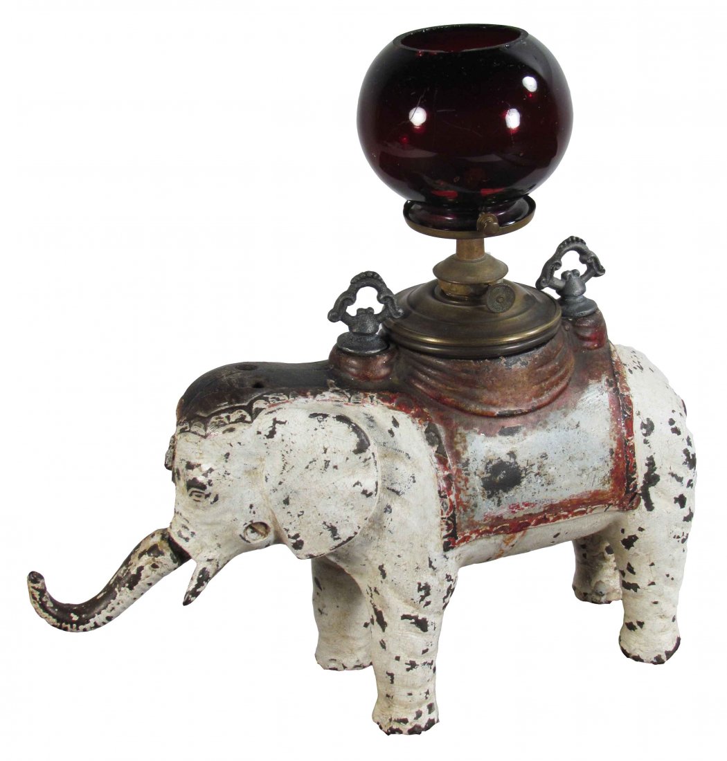 Cast Iron Figural Cigar Tip Cutter and Lighter: Cast Iron Figural Cigar Tip Cutter and Lighter. Pull down elephant's trunk to cut tips. Most original paint in tact. Very good working condition. 11 X 11 1/2 X 4 inches.
