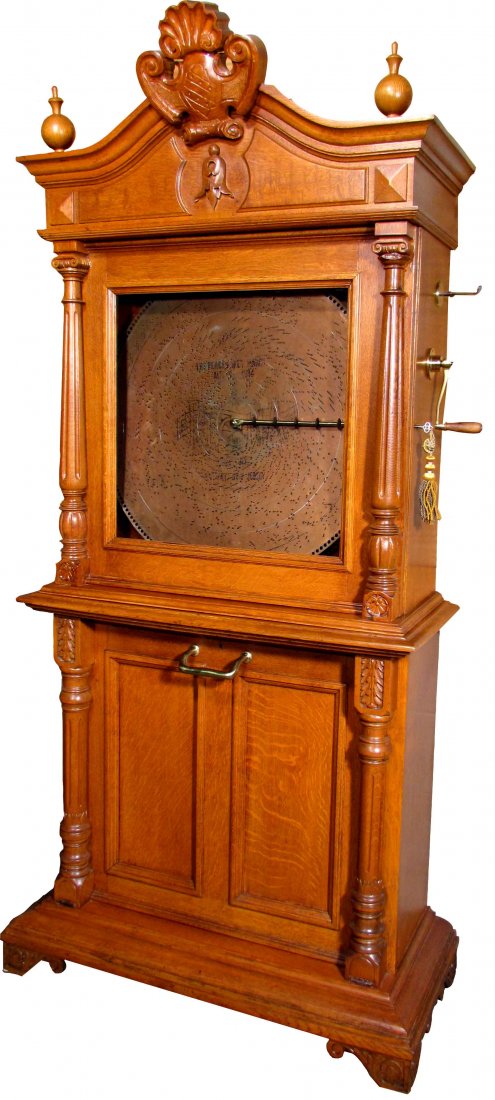 Reginaphone Music Box: Reginaphone Upright Single Disc Player #21195. Coin Operated, plays 27 inch disc. Comes with eight discs. Beautiful working condition 39 X 82 X 17 1/2 inches.