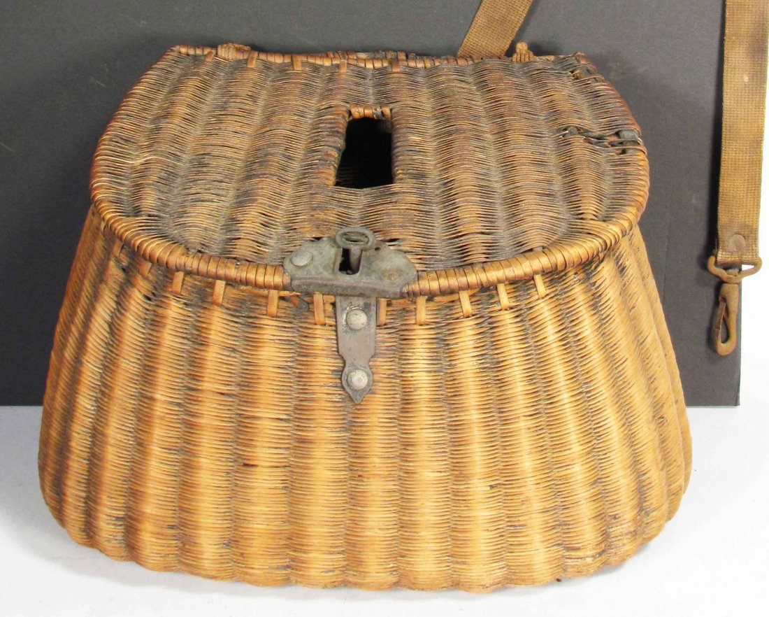 Fishing Creel: Fishing Creel. Tight rattan weave. Brass key turn lock assembly. Marked "JAP" on back with original canvas strap. Some damage on top otherwise good condition. 11 X 7 1/2 X 4 3/4 inches.