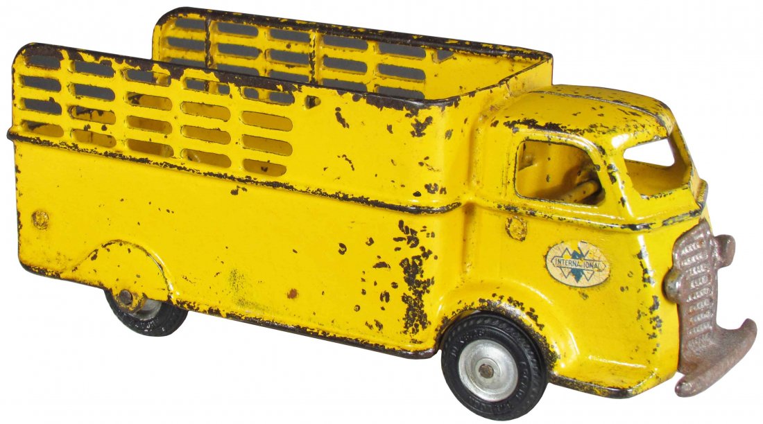 Arcade Toy Co. Cast Iron Stake Bed Toy Truck: Arcade Toy Co. Cast Iron International Stake Bed Toy Truck, yellow. Overall good condition. 9 1/2 inches long.