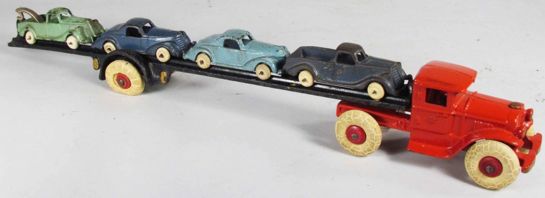 Cast Iron Toy Car Hauler: Cast Iron Toy Car Hauler. Red cab with black trailer. Comes with four vehicles. 18 inches long.
