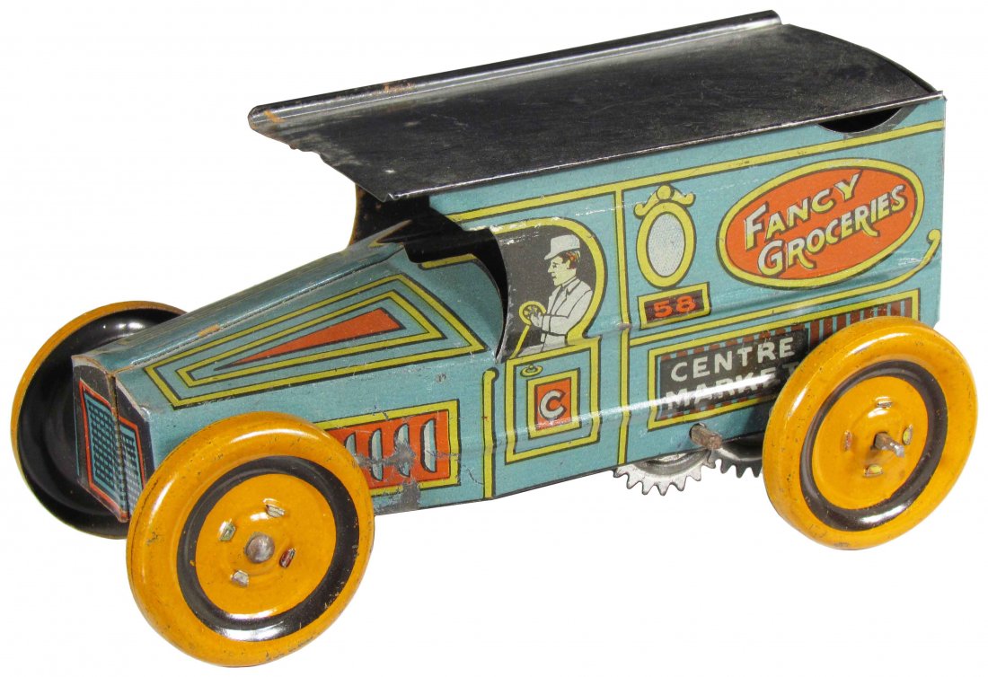 J. Chein "The Fancy Groceries" Tin Toy: J. Chein "The Fancy Groceries" Tin Litho Wind Up Toy Truck, 1918. Minor paint loss, otherwise excellent condition. 6 inches long.