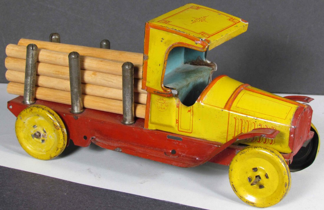 J. Chein No. 224 Lumber Truck Tin Toy: J. Chein No. 224 Lumber Truck Tin Litho Toy, ca. 1920s. Light scratches and paint loss otherwise good condition. 8 1/2 inches long.