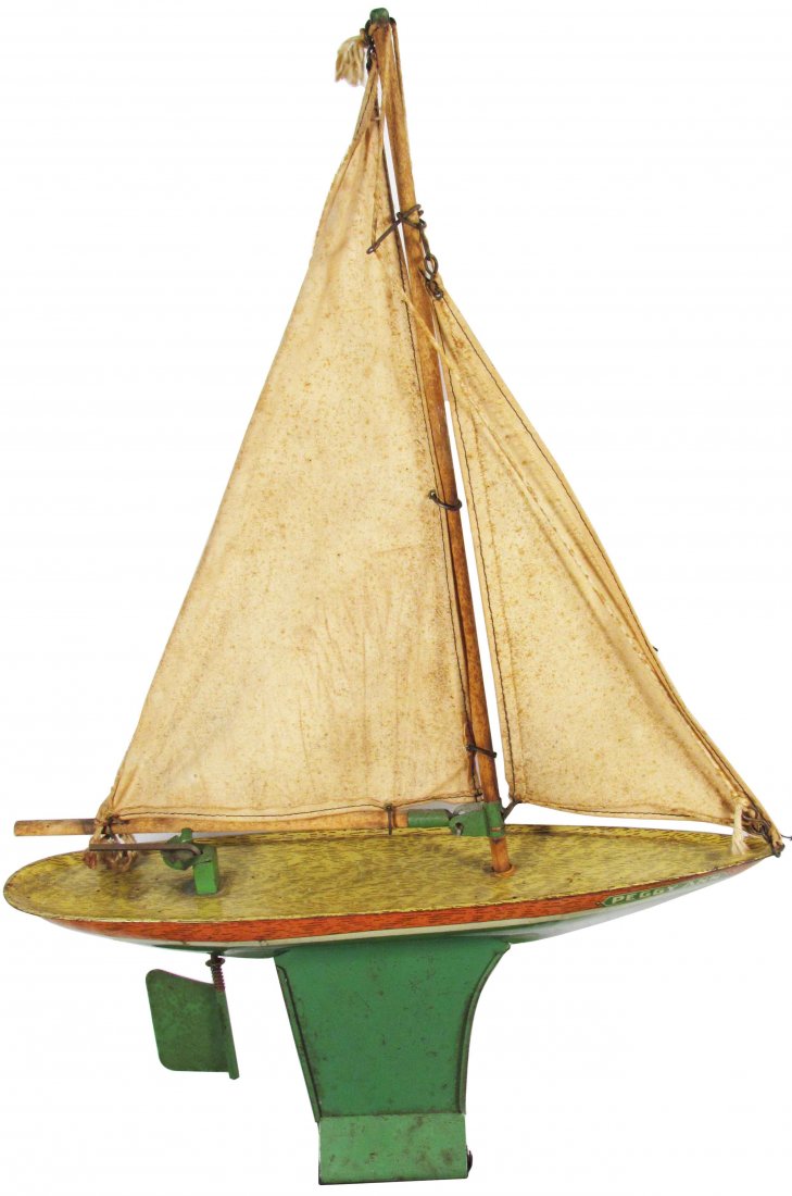 J. Chein "Peggy Ann" Tin Litho Toy Boat: J. Chein "Peggy Ann" Tin Litho Toy Boat. Wood mast and fabric sails. Minor paint loss, rust and staining to fabric sails otherwise good condition. 18 1/2 inches tall.