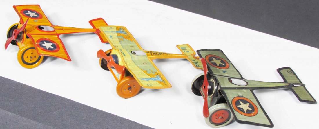 Three J. Chein Tin Wind Up Tin Litho Toys: Three Tin Wind Up Planes by J. Chein including Spirit of America and Orange and Green Mono-wings. Overall very good condition. Each wingspan measures 6 3/4 inches.