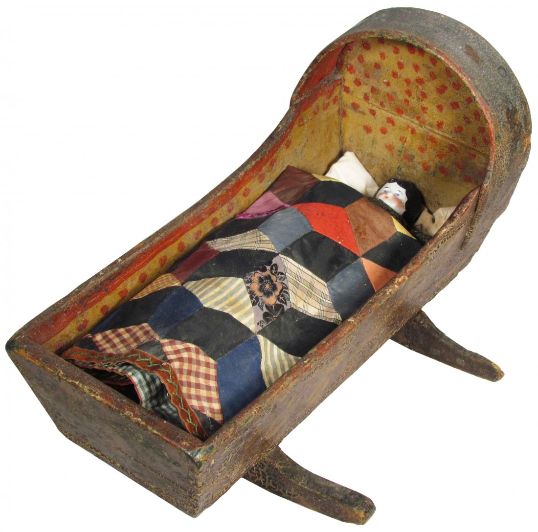 Primitive Doll Cradle and Bisque Doll: Primitive Doll Cradle and Bisque Doll. Cradle interior is hand painted yellow with red polka dots. Patchwork quilt is soiled, doll's right foot and left arm missing. Overall good original condition. 1