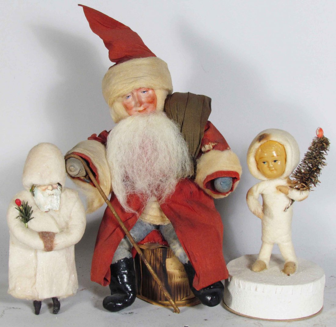 Three Early Christmas Figures: Three Early Christmas Figures. Original "Snow Baby" candy container with celluloid face. Gebruder Heubach Santa candy container with bisque face, spun cotton beard and crepe paper robe. "Waddin" early