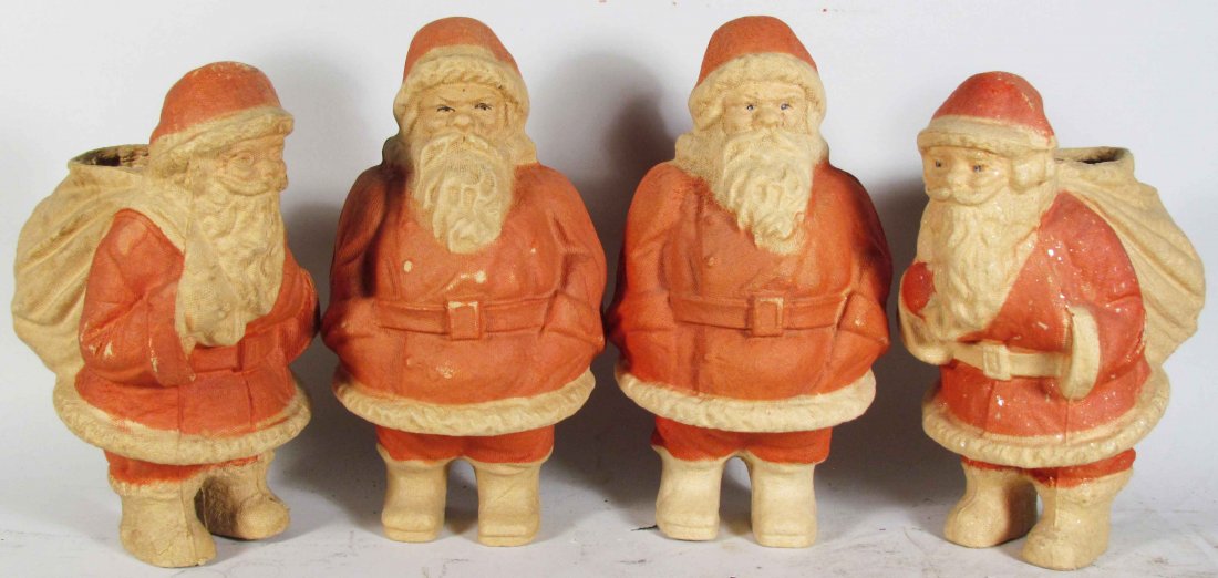 Four Cardboard Santa Candy Containers: Four Pressed Cardboard Santa Candy Containers, ca. 1930. Two have glass bead eyes and one still has sprinkled mica. Overall very good condition. Tallest measures 9 1/2 inches tall.