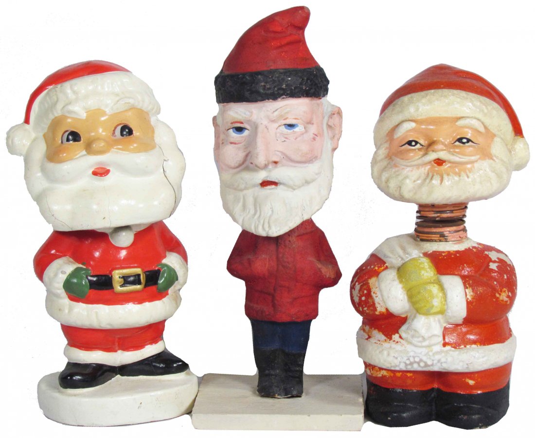Three Santa Figure Nodders: Three Santa Figure Nodders. The Belsnickle Style is paper mache is Ca. 1920 and marked Germany. The smallest of the three is a bank, the other has a crack down the left side of his beard. Tallest meas