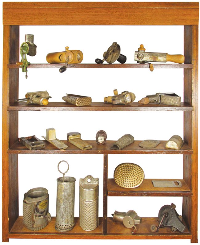 Turn of the Century Collection of Spice Graters: Turn of the Century Collection of Rare Spice Graters in oak wall display shelf. 22 graters. Oak shelf measures 24 1/2 X 28 3/4 X 4 inches.