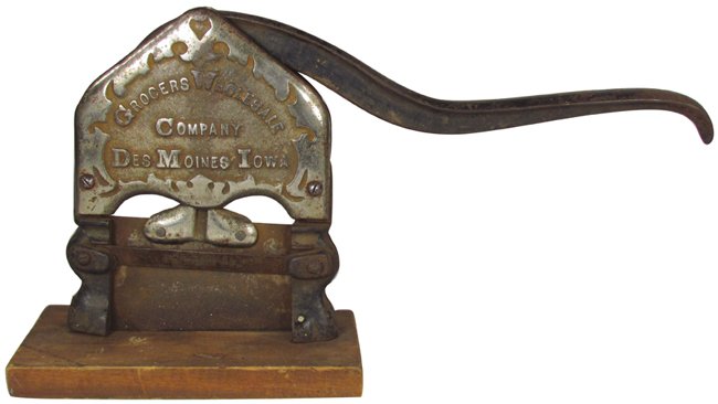 Grocers Wholesale Company Tobacco Plug Cutter: Grocers Wholesale Company Tobacco Plug Cutter. Des Moines, Iowa. Nickel plated cast iron mounted on wood. Plating worn otherwise fair condition. 15 inches long.