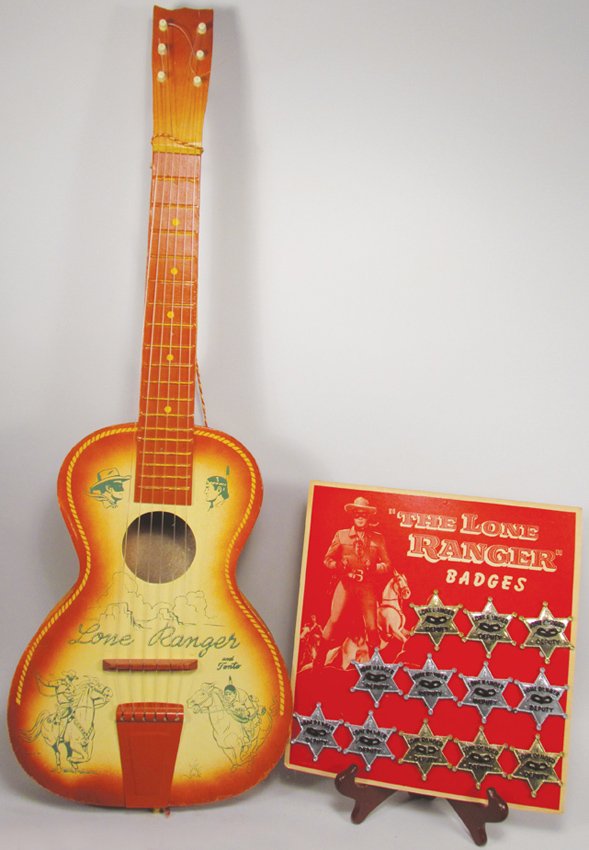 Lone Ranger Items: Lone Ranger Badge Store Display with product and Lone Ranger Child's Guitar. Near mint to excellent condition. Display measures 10 1/2 X 11 1/4 inches.